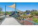 A spacious playground includes a variety of play equipment for children, set among landscaped grounds at 4511 Stardusk Falls Ave, North Las Vegas, NV 89084
