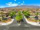 A picturesque street view features charming homes with well-maintained landscaping and a mountain view in the background at 4511 Stardusk Falls Ave, North Las Vegas, NV 89084