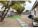Spacious backyard with rock landscaping, patio area, and mature trees at 4618 Zia Ridge St, North Las Vegas, NV 89031