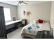 Simple bedroom with a desk, bed, and treadmill for exercise at 4618 Zia Ridge St, North Las Vegas, NV 89031