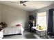 Bedroom featuring gray wood floors, neutral walls, a ceiling fan and natural light at 4618 Zia Ridge St, North Las Vegas, NV 89031