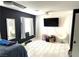 Bright bedroom featuring white tile floors, a ceiling fan, and workout equipment at 4618 Zia Ridge St, North Las Vegas, NV 89031