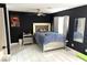 Contemporary primary bedroom with dark walls, tile floors and a luxurious upholstered bed at 4618 Zia Ridge St, North Las Vegas, NV 89031
