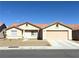 Charming single-story home featuring a terracotta tile roof, two-car garage and low-maintenance desert landscaping at 4618 Zia Ridge St, North Las Vegas, NV 89031