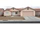 Charming single-story home featuring a two-car garage, low maintenance desert landscaping, and a cozy front porch at 4618 Zia Ridge St, North Las Vegas, NV 89031