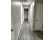 Hallway with gray wood flooring and light gray walls leading to other rooms at 4618 Zia Ridge St, North Las Vegas, NV 89031