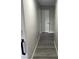 Hallway with gray wood flooring and light gray walls leading to several rooms at 4618 Zia Ridge St, North Las Vegas, NV 89031