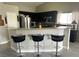 Kitchen featuring sleek flooring, dark cabinets, stainless steel appliances, and a granite topped bar-style seating area at 4618 Zia Ridge St, North Las Vegas, NV 89031