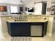 Kitchen view with a stainless steel dishwasher, sink, granite countertops, and an open view of the living room at 4618 Zia Ridge St, North Las Vegas, NV 89031