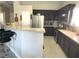 Updated kitchen featuring stainless steel appliances and a breakfast bar with granite countertops at 4618 Zia Ridge St, North Las Vegas, NV 89031