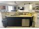 Kitchen featuring sleek flooring, dark cabinets, stainless steel appliances, and a granite topped bar-style seating area at 4618 Zia Ridge St, North Las Vegas, NV 89031