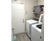 Functional laundry room with modern appliances, shelving, and grey floors at 4618 Zia Ridge St, North Las Vegas, NV 89031