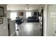 Open-concept living area featuring sleek flooring, a modern ceiling fan, and two comfortable reclining sofas at 4618 Zia Ridge St, North Las Vegas, NV 89031