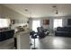 Bright open-concept living area with sleek flooring, large windows, modern lighting, and comfortable seating at 4618 Zia Ridge St, North Las Vegas, NV 89031