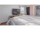 Cozy bedroom featuring a large television, window, and access to a bathroom at 5109 Gains Mill St, Las Vegas, NV 89122