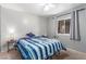 Comfortable bedroom with a bed, side table, window, and neutral-toned walls at 5109 Gains Mill St, Las Vegas, NV 89122