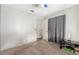 Bedroom with neutral walls, carpet flooring, and a small black table with a lamp at 5109 Gains Mill St, Las Vegas, NV 89122