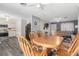 Open-concept dining area with wooden table and chairs, adjacent to kitchen and living room at 5109 Gains Mill St, Las Vegas, NV 89122