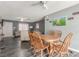 Cozy dining room featuring wood-look floors, a ceiling fan, and an adjacent seating area at 5109 Gains Mill St, Las Vegas, NV 89122
