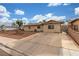 Charming single-story home featuring desert landscaping, a long driveway, and secure gated access in the front at 5109 Gains Mill St, Las Vegas, NV 89122
