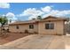 Charming single-story home featuring desert landscaping, a long driveway, and secure gated access in the front at 5109 Gains Mill St, Las Vegas, NV 89122