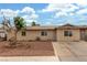Charming single-story home featuring desert landscaping, a long driveway, and secure gated access in the front at 5109 Gains Mill St, Las Vegas, NV 89122