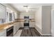 Efficient kitchen features wood countertops, stainless steel appliances, and gray cabinets at 5109 Gains Mill St, Las Vegas, NV 89122