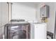 Modern laundry room with a black Samsung washer and white Samsung dryer at 5109 Gains Mill St, Las Vegas, NV 89122