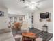 Cozy living room featuring neutral walls, wood-look floors, comfortable seating, and a ceiling fan at 5109 Gains Mill St, Las Vegas, NV 89122