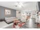 Cozy living room featuring neutral walls, wood-look floors, comfortable seating, and a ceiling fan at 5109 Gains Mill St, Las Vegas, NV 89122