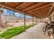 Covered patio with wooden supports overlooking the backyard, perfect for outdoor dining at 5109 Gains Mill St, Las Vegas, NV 89122
