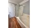 This bathroom has a glass shower, soaking tub, and wood-look flooring at 5165 Briar Meadow Way, Las Vegas, NV 89118