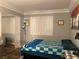 Calm bedroom featuring a sliding closet door, plantation shutters, and natural light at 5165 Briar Meadow Way, Las Vegas, NV 89118