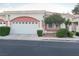 Home featuring an attached garage and beautiful landscaping at 5165 Briar Meadow Way, Las Vegas, NV 89118