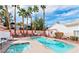 Outdoor pool with jacuzzi, palm trees, and lounge chairs, perfect for relaxation and leisure at 5165 Briar Meadow Way, Las Vegas, NV 89118