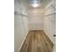 Walk-in closet with bright hardwood floors and ample storage space at 5165 Briar Meadow Way, Las Vegas, NV 89118
