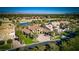 Stunning aerial view of a luxury home, golf course, and sparkling lakes, offering a serene setting at 52 Innisbrook Ave, Las Vegas, NV 89113