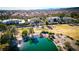 Aerial of large home situated on the golf course in a neighborhood with a lake nearby at 52 Innisbrook Ave, Las Vegas, NV 89113