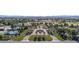 Aerial view of the community's entrance, tennis courts, golf course, and perfectly manicured landscaping at 52 Innisbrook Ave, Las Vegas, NV 89113