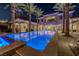 Luxurious backyard featuring a large pool with elegant lighting and manicured landscaping at twilight at 52 Innisbrook Ave, Las Vegas, NV 89113