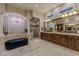 Bright bathroom featuring a soaking tub, glass shower, vanity, and stylish decor at 52 Innisbrook Ave, Las Vegas, NV 89113