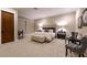 A spacious bedroom featuring a sitting area, and a luxurious upholstered bed at 52 Innisbrook Ave, Las Vegas, NV 89113