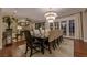 Elegant dining room with a chandelier, hardwood floors, a large table, and access to the outdoor space at 52 Innisbrook Ave, Las Vegas, NV 89113