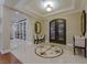 Elegant foyer with tile flooring, a decorative in-lay, an ornate double door entry, and a seating area at 52 Innisbrook Ave, Las Vegas, NV 89113