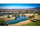 Tranquil golf course view with a serene pond, lush fairways, and distant cityscape on the horizon at 52 Innisbrook Ave, Las Vegas, NV 89113