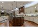 Gourmet kitchen features custom cabinets, granite counters, and large island at 52 Innisbrook Ave, Las Vegas, NV 89113