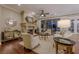 Cozy living room with a fireplace, hardwood floors, comfortable seating, and large windows looking out to the pool at 52 Innisbrook Ave, Las Vegas, NV 89113