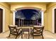 Relaxing patio with comfortable seating overlooking a well-manicured landscape at night at 52 Innisbrook Ave, Las Vegas, NV 89113