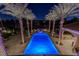 Striking aerial view of a backyard pool surrounded by tall palm trees and green landscaping at 52 Innisbrook Ave, Las Vegas, NV 89113