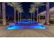Swimming pool at night with palm trees and outdoor seating; lit up for a relaxing atmosphere at 52 Innisbrook Ave, Las Vegas, NV 89113